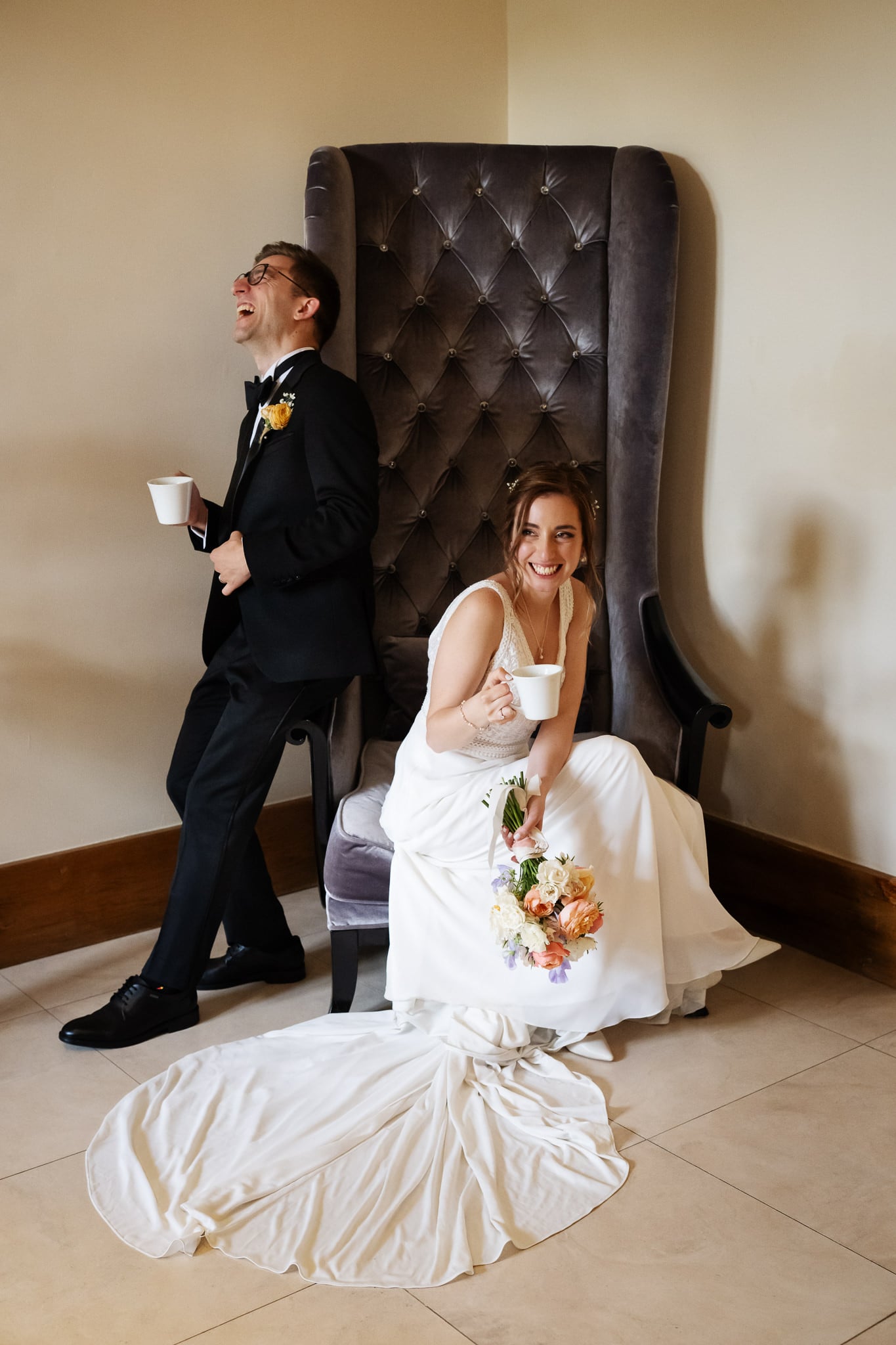 A man and bride sit together on a chair at Notley Abbey in Buckinghamshire.