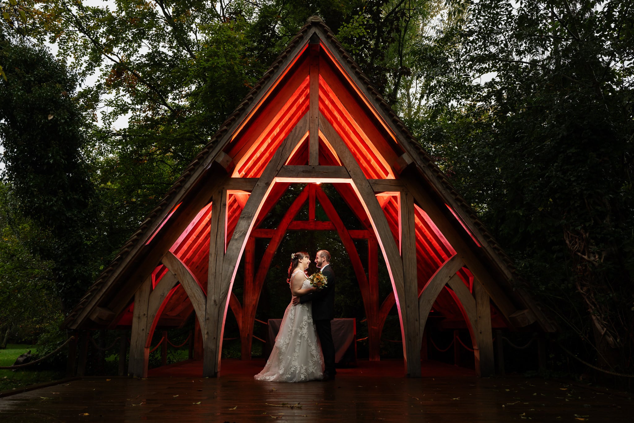 An evening wedding portrait under the gazebo at Rivervale Barn