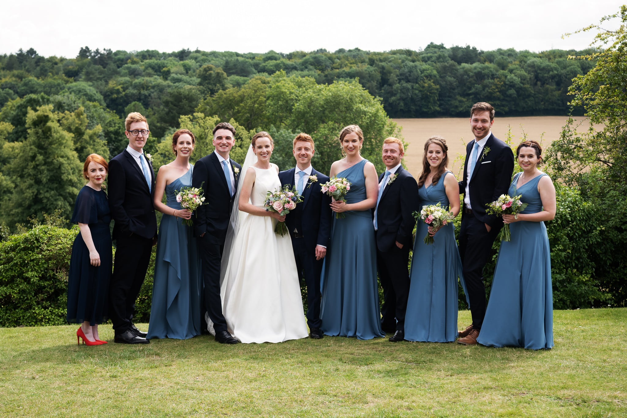 A bridal party group photo outside De Vere Latimer Estate