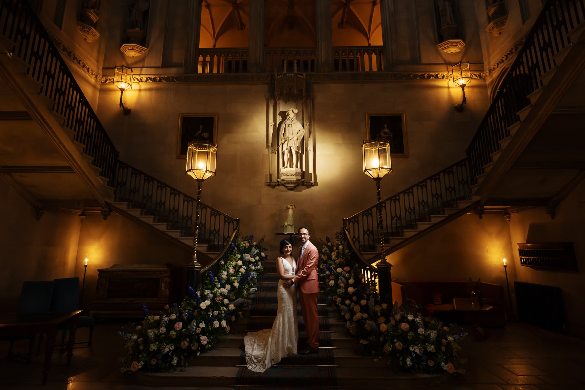 A wedding portrait of the bride and groom on the staircase at Ashridge House