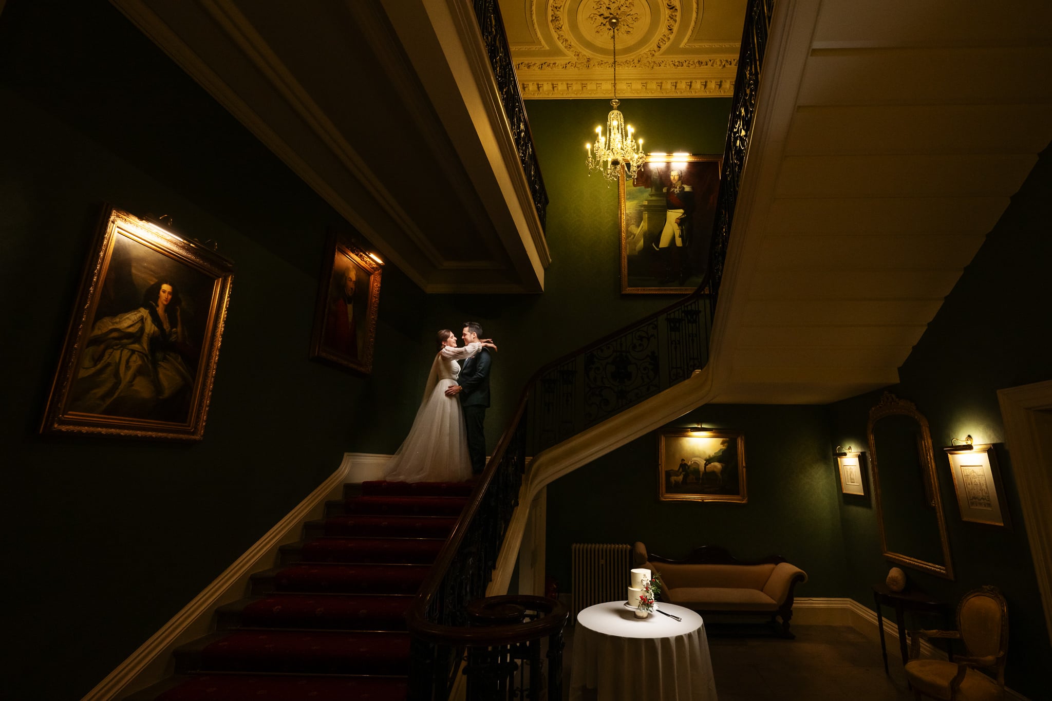 A couple portrait on the stairs at Addington Palace